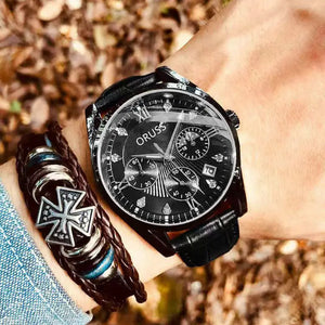 Black wristwatch with detailed face on a wrist, paired with a braided leather bracelet.