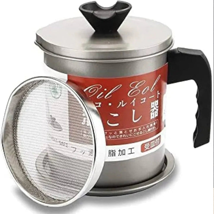 Stainless steel tea press with red label and black handle on a white background