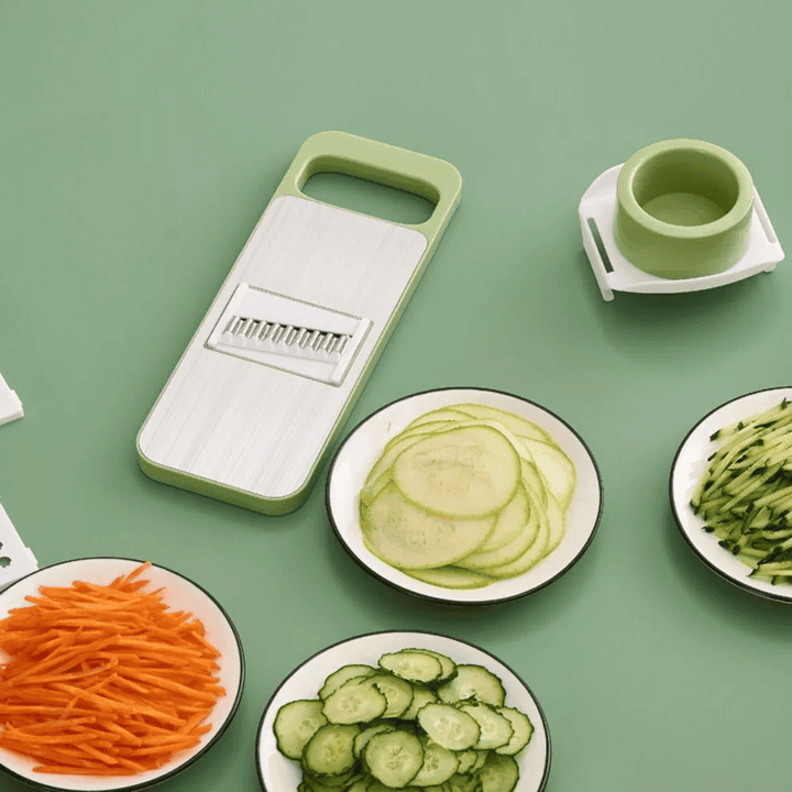 Green vegetable slicer with sliced vegetables on a green background