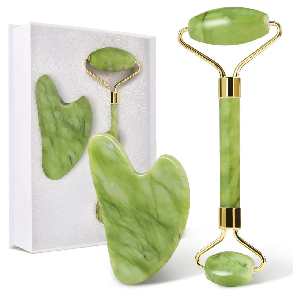 Green jade facial roller and gua sha tool set with gold accents on a white background